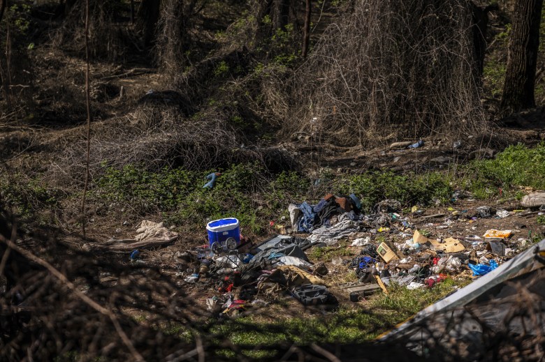 Debris from homeless encampments at a regional park lies scattered due to the recent flooding in Sacramento on April 11, 2023.