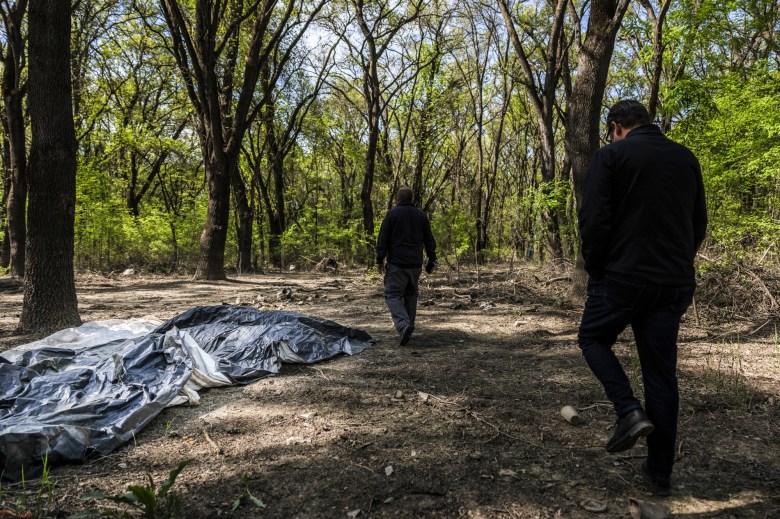 City homeless coordinators walk through a regional park in Sacramento where several homeless encampments are located on April 11, 2023.