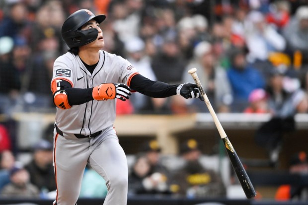 San Francisco Giants' Jung Hoo Lee (51) watches the flight of his solo home run during the eighth inning of a baseball game against the San Diego Padres, Saturday, March 30, 2024, in San Diego. (AP Photo/Denis Poroy)