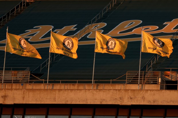 The Oakland Athletics World Series Championship flags wave in the center field upperdeck during a game against the Arizona Diamondbacks at the Oakland Coliseum in Oakland, Calif., on Tuesday, May 16, 2023. (Ray Chavez/Bay Area News Group)