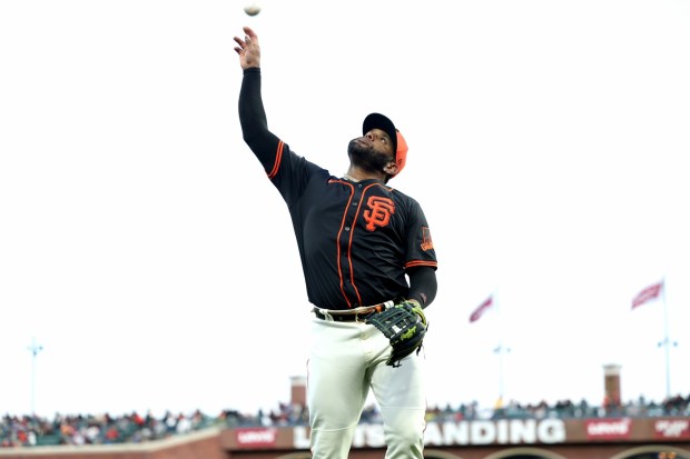 San Francisco Giants Pablo Sandoval shores throws the ball to fans at the end of the eighth inning of Game 2 of the Bay Bridge series against the Oakland Athletics at Oracle Park in San Francisco, Calif., on Tuesday, March 26, 2023. (Ray Chavez/Bay Area News Group)