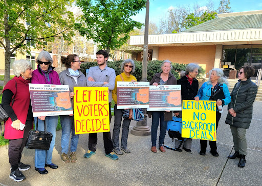 Valley's Edge opponents -- including Jared Geiser, fourth from left, and Marty Dunlap, second from right -- urge the Chico City Council to put their referendum to voters at a news conference before the meeting Tuesday, April 18, 2023, in Chico, California. (Evan Tuchinsky/Enterprise-Record)