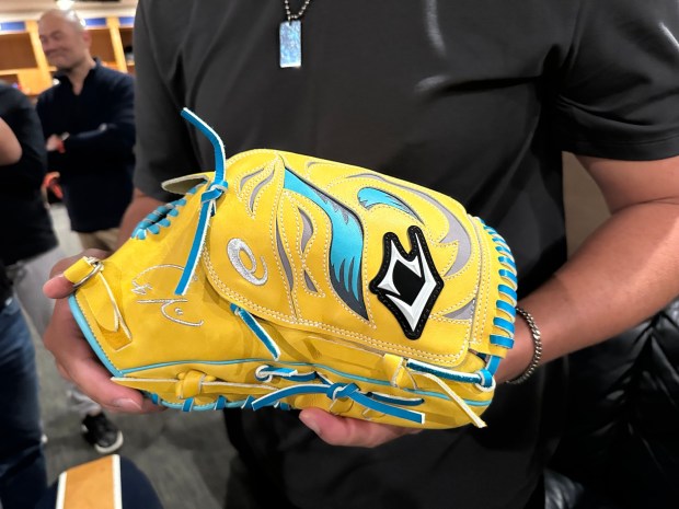 Giants pitcher Kai-Wei Teng displays the glove gifted to him by Padres starter Yu Darvish. (Evan Webeck / Bay Area News Group)