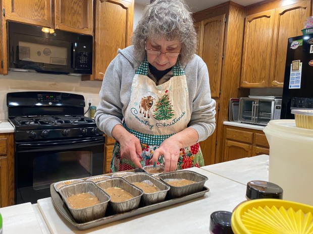 Margaret Shoffner, owner of Maggie's Sweets, a home-based bakery, readies some loaves of zucchini bread to go in the oven Monday, March 4, 2024 in Oroville, California. (Kyra Gottesman/Mercury-Register)