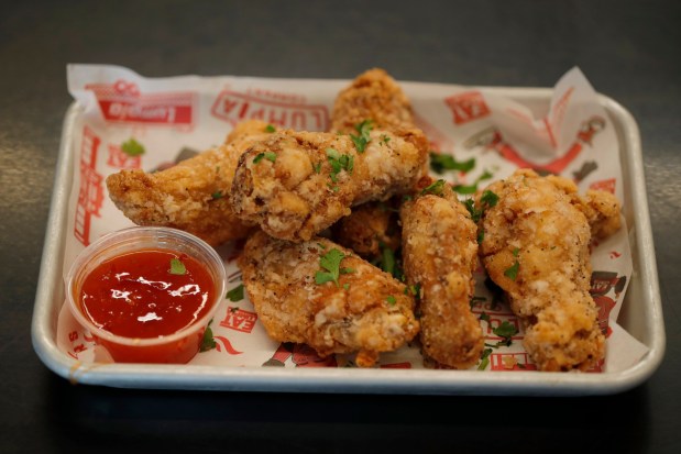 Adobo seasoned chicken wings are served at The Lumpia Company in Oakland, Calif., on Thursday, Feb. 8, 2024. This year will be the sixth season that the company, co-owned by local rapper E-40 and Hayward native Alex Retodo, have been serving their fried spring rolls to San Francisco Giants fans at Oracle Park. (Jane Tyska/Bay Area News Group)