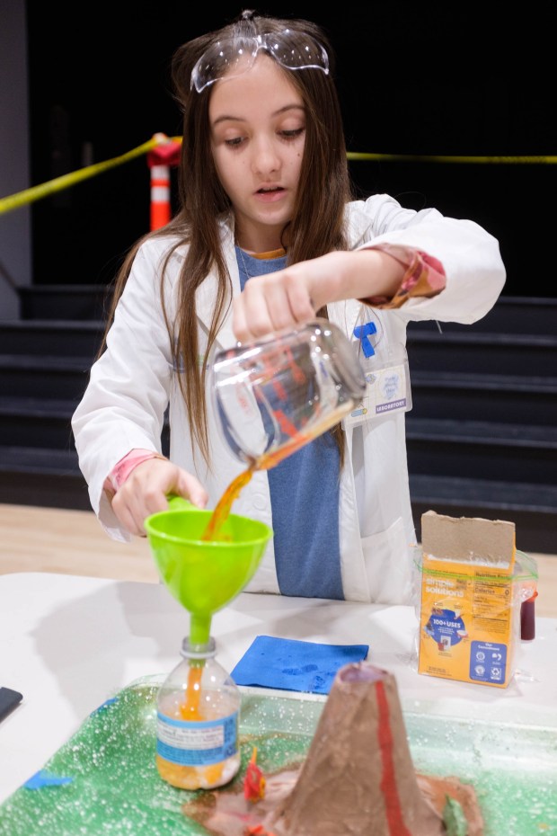 Lilliana Carrasco-Scruby, student of Ophir Elementary School, demonstrates a vinegar and baking soda "volcano" experiemnt during the Oroville Kiwanis Science Fair on Saturday, March 9, 2024 at the Oroville Convention Center in Oroville, California. (Michael Weber/Mercury-Register)