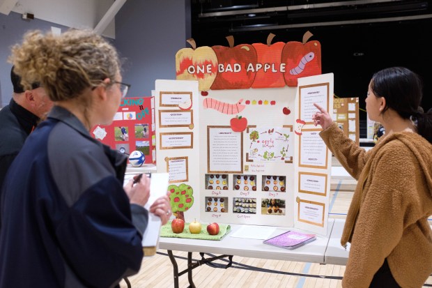 Tala Boles, right, student of Oroville Christian School, presents her project "One Bad Apple" to judges at Oroville Kiwanis Science Fair on Saturday, March 9, 2024 at the Oroville Convention Center in Oroville, California. (Michael Weber/Mercury-Register)