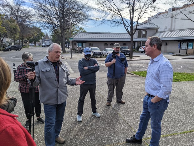 Chico Mayor Andrew Coolidge, right, fields questions from resident Rob Berry, third from left, after a press conference held in Chico, California, on the Warren v. Chico settlement agreement Jan. 18, 2022. (Jake Hutchison/Enterprise-Record)