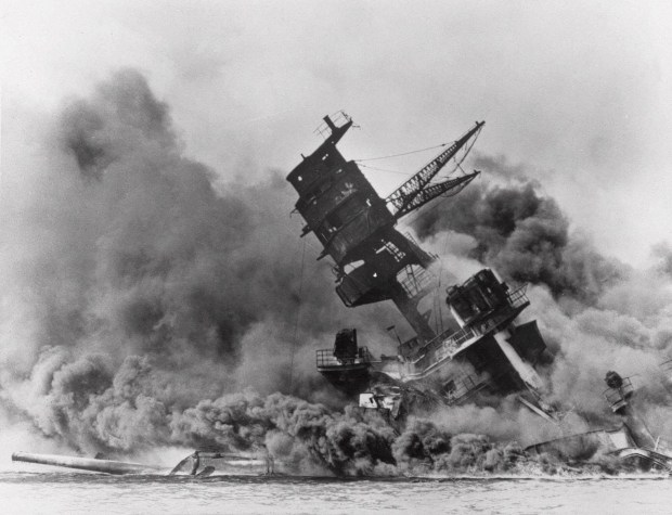 ** FILE ** In this Dec. 7, 1941 file photo, the battleship USS Arizona belches smoke as it topples over into the sea during a Japanese surprise attack on Pearl Harbor, Hawaii. With an eye on the immediate aftermath of the 1941 attack on Pearl Harbor, thousands of World War II veterans and other observers are expected on Sunday, Dec. 7, 2008 to commemorate the 67th anniversary of the devastating Japanese military raid. (AP Photo)