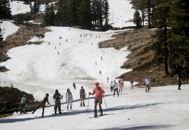 Skiers head down the Weasel run past bare ground at Alpine Meadows ski area in Alpine Meadows, Calif., on Saturday, July 1, 2023. Part of Palisades Tahoe, the area held their Freedom Fest event this weekend with skiing and snowboarding through July 4. (Jane Tyska/Bay Area News Group)