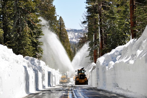 Snow piled on Tioga Road is blown off to the side in a photo Yosemite National Park posted to Facebook on May 14 to announce there is still no date to reopen the road. Park crews have cleared 11 of 45 and a half miles of road throughout the park's high country as of May 13, 2023. (Courtesy Yosemite National Park)