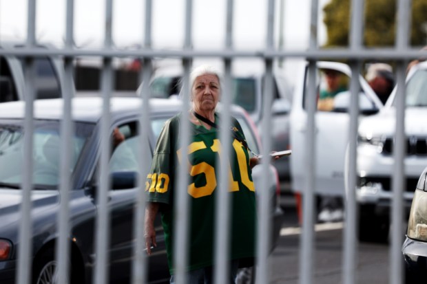 Oakland Athletics fan Debi Driver, of Brentwood, looks on as she waits for the gates to open for the MLB opening day game against the Cleveland Guardians at the Coliseum in Oakland, Calif., on Thursday, March 28, 2024. The gates were opened two and a half hours before the start of the game. (Ray Chavez/Bay Area News Group)