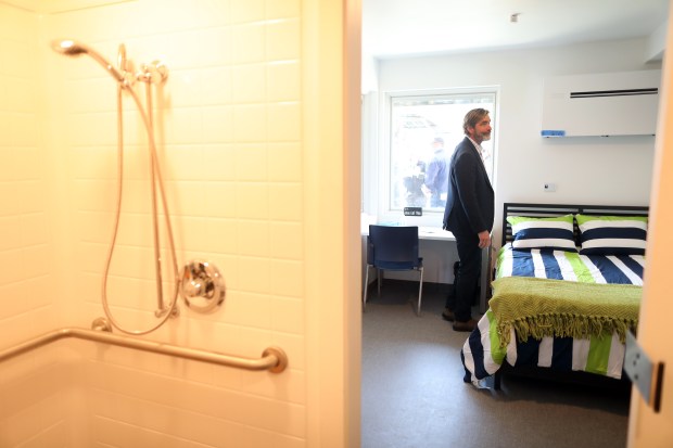 Joe Stockwell tours a housing unit at the San Mateo County Navigation Center on Tuesday, April 18, 2023, in Redwood City, Calif. The $57 million facility has 240 housing units, a dinning area, meeting space, laundry, and a dog run.