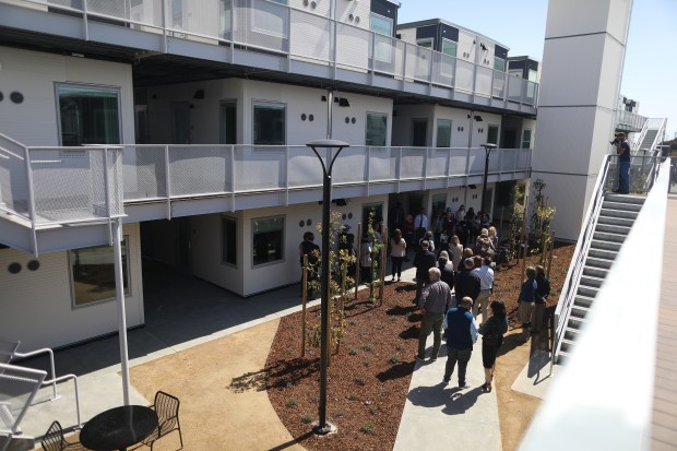 Visitors tour the San Mateo County Navigation Center on Tuesday, April 18, 2023, in Redwood City, Calif.