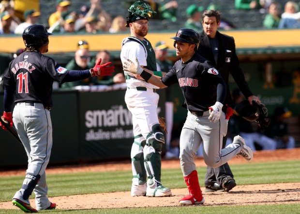 Cleveland Guardians' Steven Kwan is congratulated by Jose Ramirez after hitting a solo home run against the Oakland A's in the seventh inning, Saturday, March 30, 2024, at the Oakland Coliseum in Oakland, Calif. (Karl Mondon/Bay Area News Group)