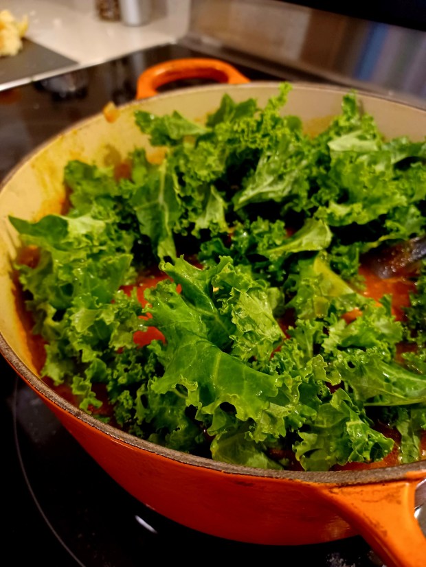 You'll add the kale in two waves, allowing each to wilt. (Amy Drew Thompson/Orlando Sentinel)